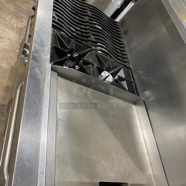 Southbend stainless steel gas 6-burner range with 24" griddle, double oven, backsplash, salamander shelf, and casters.