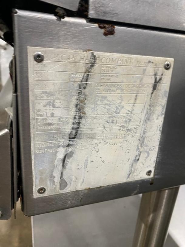 Vulcan commercial stainless steel griddle label with specifications, part of flat griddle on casters with undershelf cart.