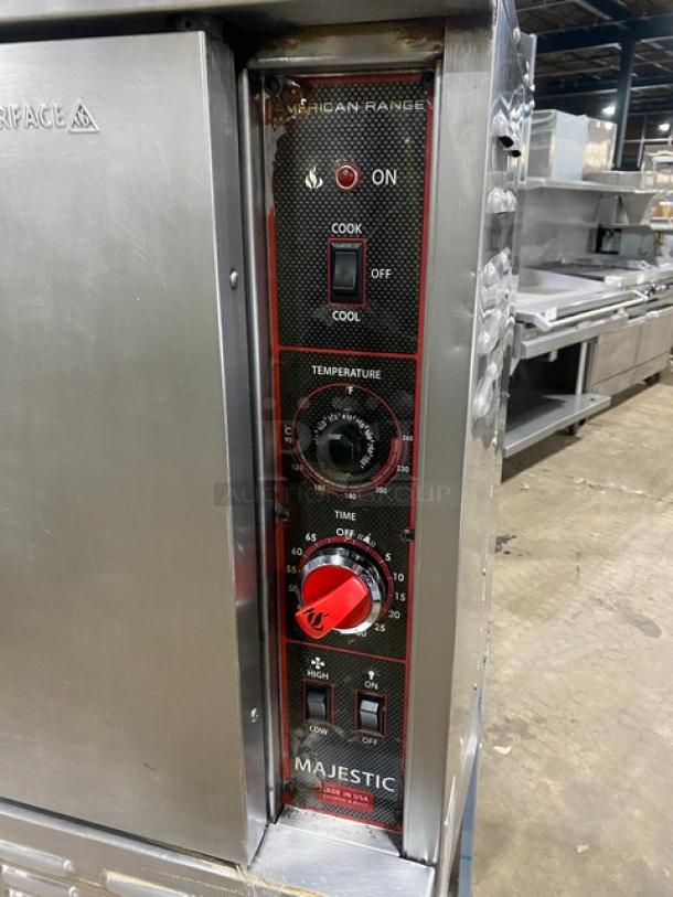 American Range stainless steel gas-powered single stack convection oven with wired rack, temperature and timer controls, on legs.