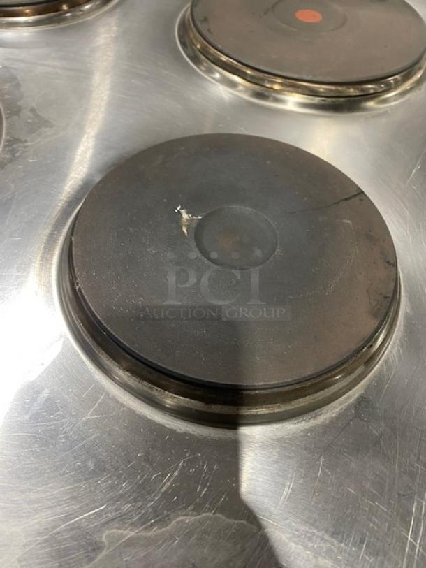 Cookline 2023 commercial stainless steel electric 4-burner range, Model ER24-208, with crack on burner surface.