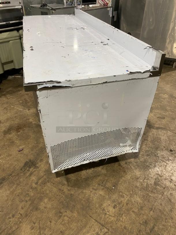 LIKE NEW Custom Cool LB93SC 3-door stainless steel refrigerated worktop table with universal pan rack, on casters.