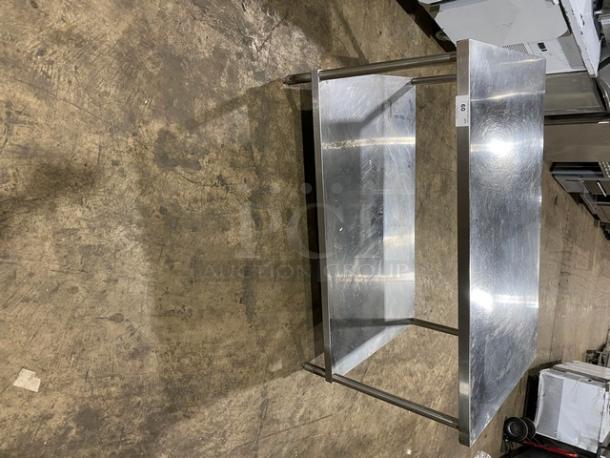 Commercial stainless steel equipment stand with single undershelf, sturdy legs, excellent condition, ideal for heavy use.