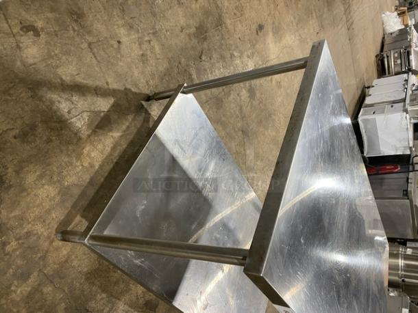 Commercial stainless steel equipment stand with single undershelf on sturdy legs, excellent condition, ideal for kitchens.