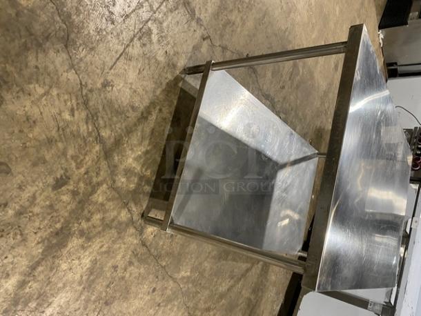 Commercial stainless steel equipment stand with single undershelf and sturdy legs. Polished finish. Good condition.
