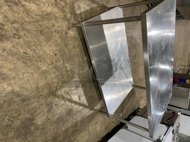 Commercial stainless steel equipment stand with single undershelf and sturdy legs. Pristine condition, ideal for kitchen use.