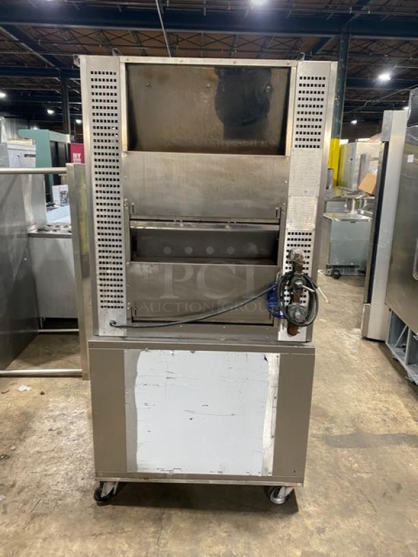 Rotisol 9505 stainless steel rotisserie oven, natural gas, with tempered glass doors and pull-out workstation, on casters.