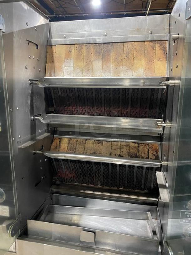 Rotisol 9505 stainless steel rotisserie oven with tempered glass doors and pull-out workstation. Natural gas, on casters.