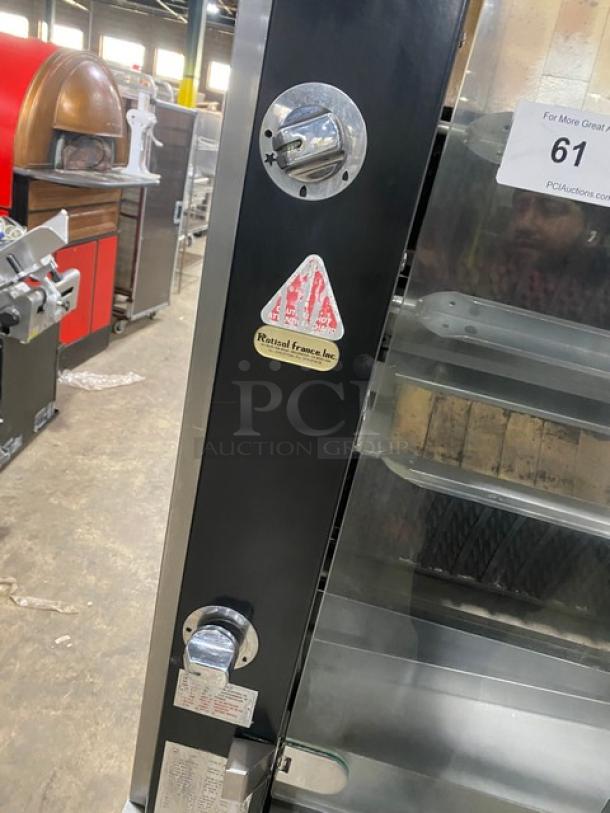 Rotisol stainless steel rotisserie oven, model 9505, with tempered glass doors, retractable workstation, and cabinet base.