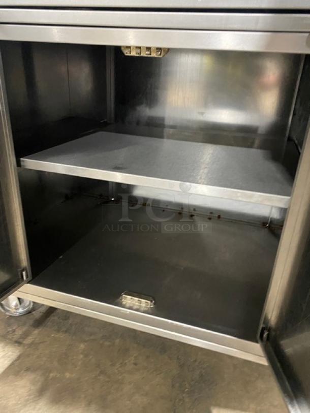 Rotisol 9505 stainless steel rotisserie oven open cabinet, model 9505, on casters, features pull-out workstation.