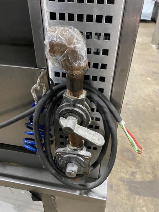 Rotisol stainless steel gas rotisserie oven, Model 9505, with glass doors, pull-out workstation, on casters. 220-240V, 1 Phase.