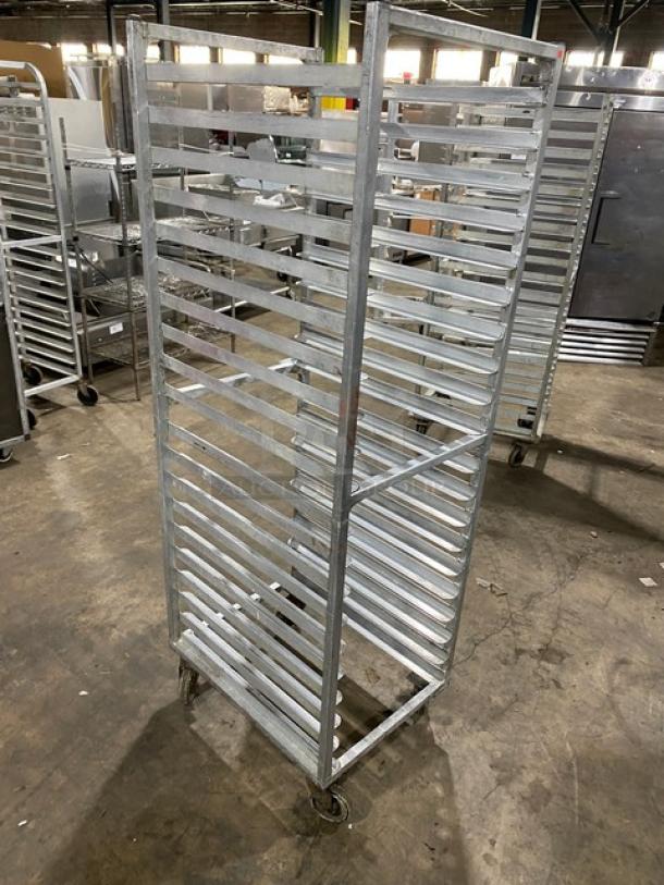 Commercial stainless steel sheet pan rack on casters, multiple shelves, sturdy construction, ideal for kitchens, good condition.