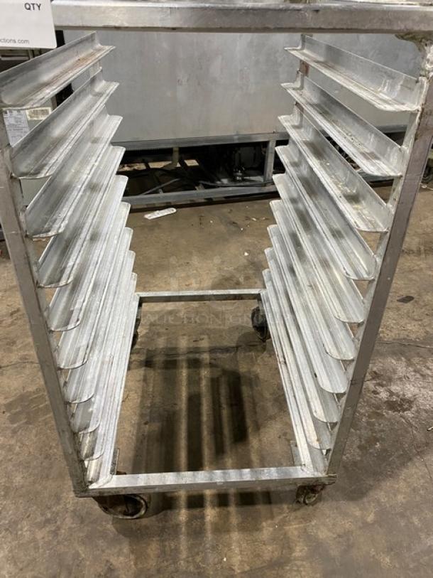 Commercial stainless steel sheet pan rack on casters, used condition, multiple slots for trays, ideal for kitchens.