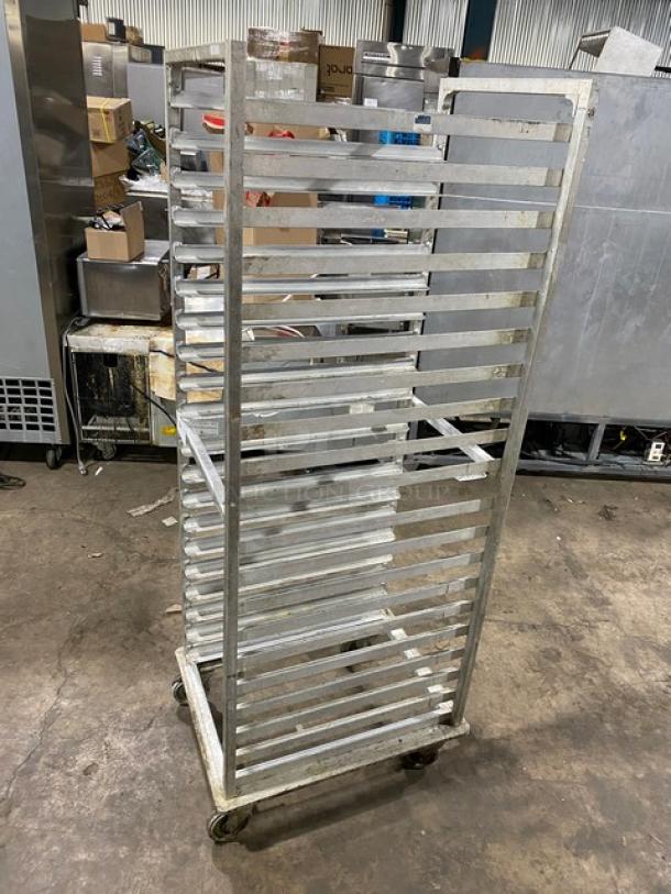 Commercial stainless steel sheet pan rack with multiple shelves, on casters for mobility, suitable for kitchen use.
