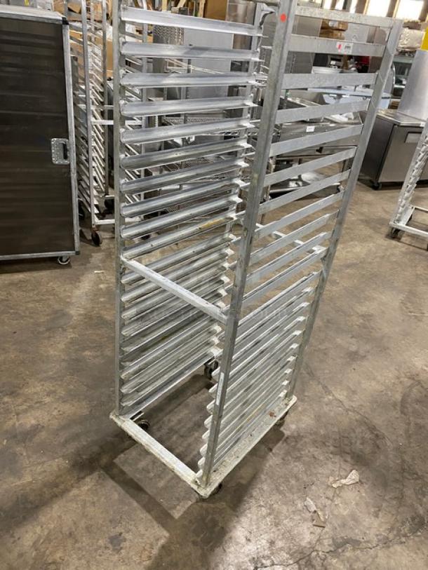 Commercial stainless steel sheet pan rack on casters, used condition, multiple shelves, industrial-grade design for kitchen use.