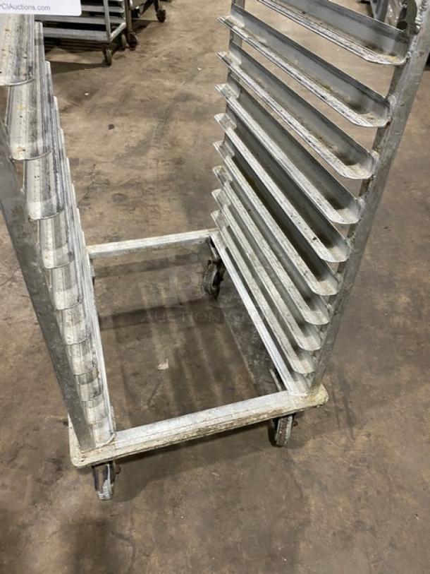 Commercial stainless steel sheet pan rack on casters, holds multiple pans, durable, industrial use, good condition.
