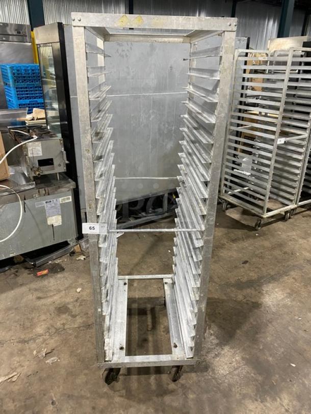 Commercial stainless steel sheet pan rack with casters, used, 20 slots, durable construction, tag labeled "65".