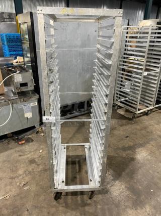 Commercial stainless steel sheet pan rack with casters, used, 20 slots, durable construction, tag labeled "65".