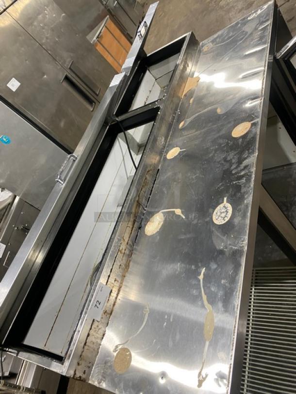 True TPP-67 stainless steel 2-door refrigerated pizza prep table on casters, showing surface wear. Serial #1-4237102.