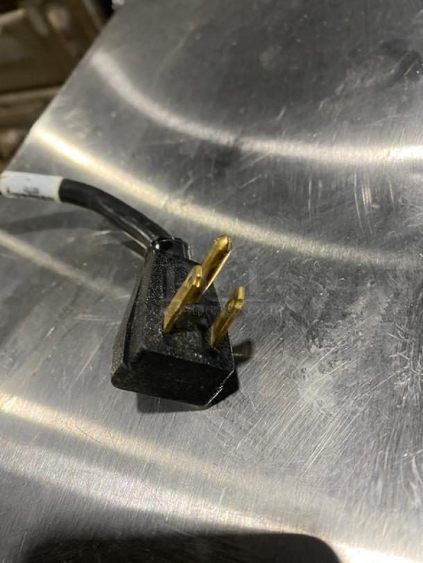 True Commercial Stainless Steel Milk Cooler plug on metal surface, Model TMC-58-S-DS-SS-HC, 115V, with wired rack.