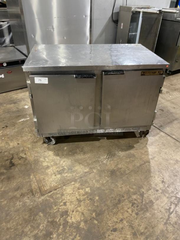 Beverage Air stainless steel 2-door refrigerated worktop cooler with poly coated rack, on casters. Signs of use visible.