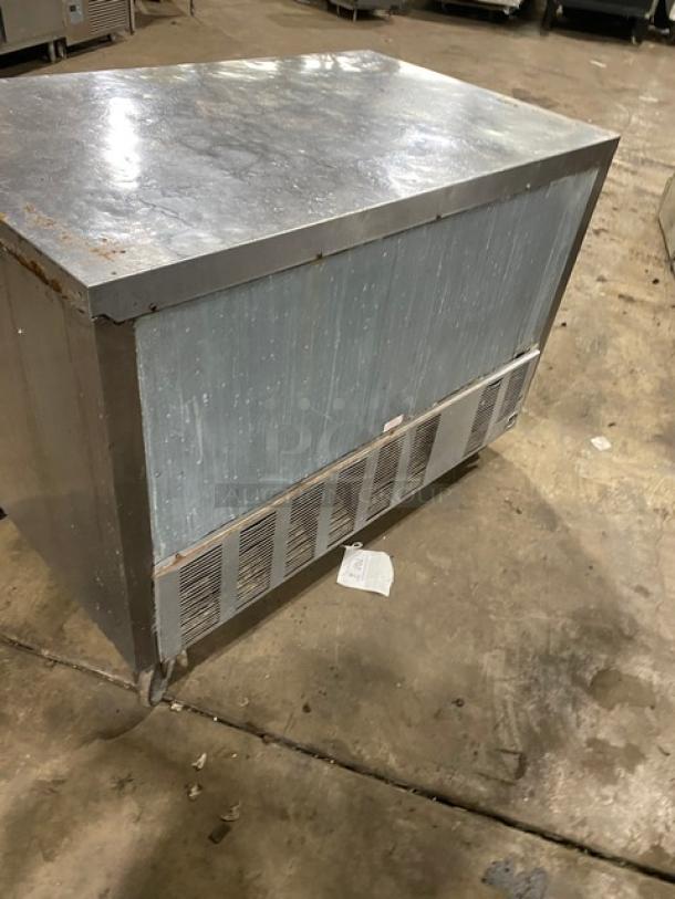 Beverage Air stainless steel 2-door refrigerated cooler on casters, with poly-coated wired rack, shows signs of wear.