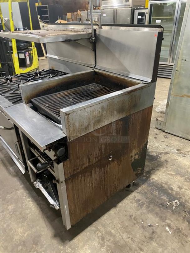 Montague commercial stainless steel 6-burner range, 24" char broiler, cheese melter, full-size oven, on casters, used condition.
