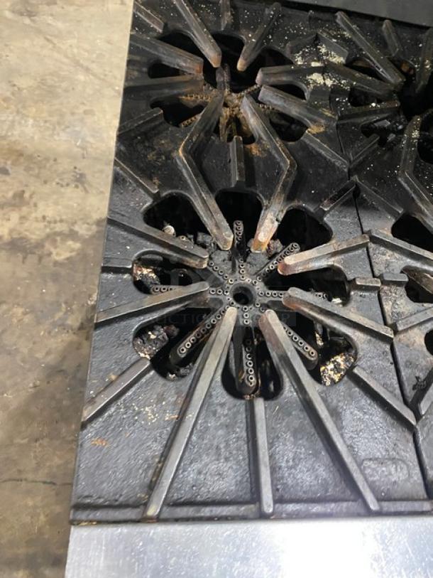 Montague stainless steel 6-burner range and 24" char broiler combo with cheese melter, natural gas, full-size oven, on casters.