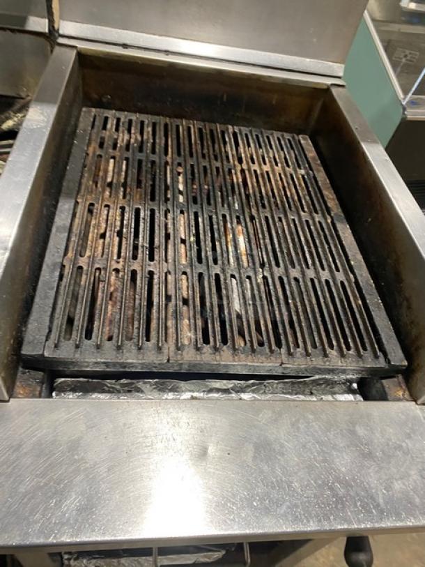 Montague commercial stainless steel 6-burner range with 24" charbroiler, cheese melter, full-size oven, on casters.