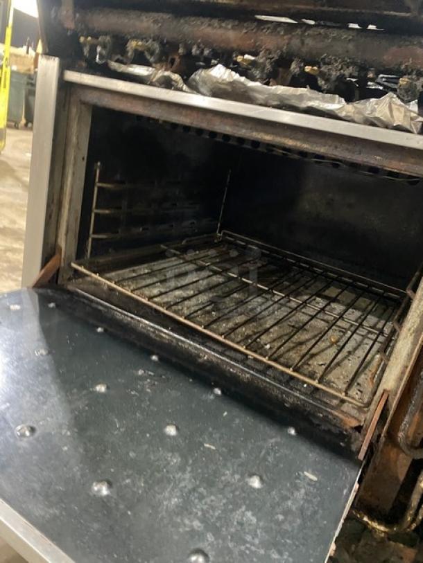 Montague stainless steel 6-burner range/char broiler combo with cheese melter, full-size oven, on casters, natural gas.