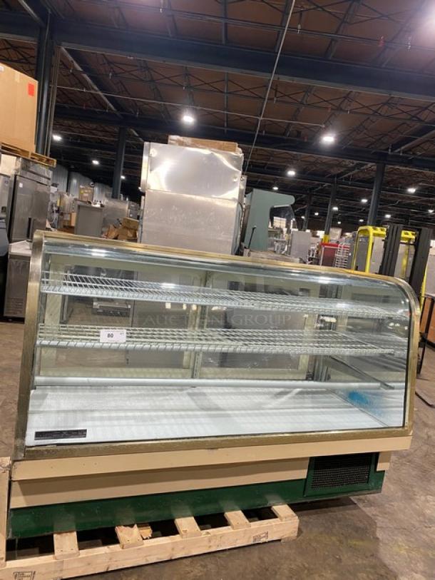 Schmidt curved glass refrigerated bakery display case, multi-tier, rear sliding doors, poly coated wire rack, excellent condition.