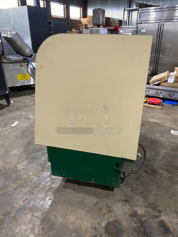 Schmidt commercial curved glass refrigerated bakery display case with rear sliding glass doors. Includes poly coated wire rack.