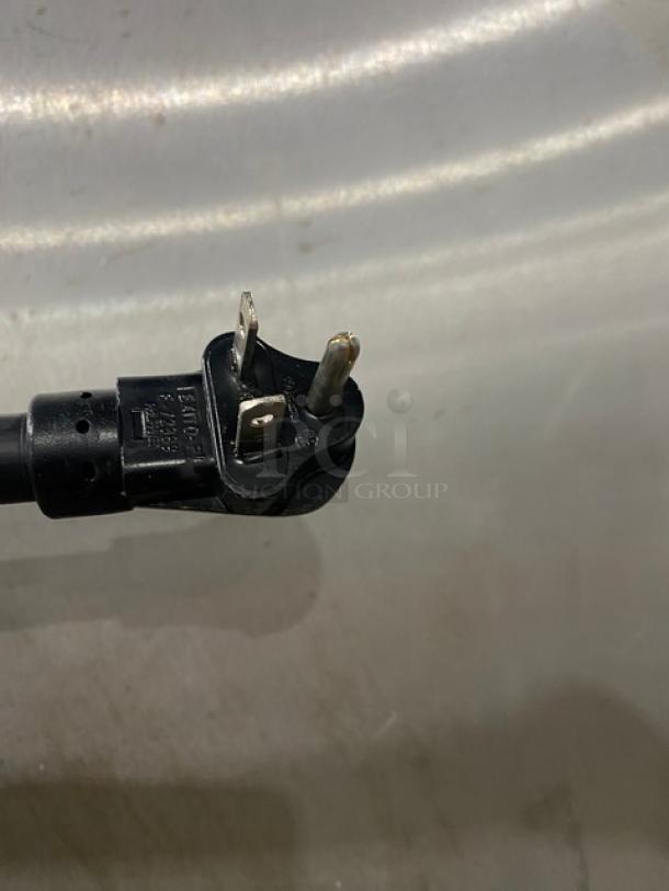 Close-up of a Metro C5-1 Series cabinet's power plug, showing standard two-prong design. Model: C517CFG4.