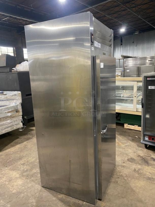 Traulsen ARI132LUT-FHS stainless steel commercial refrigerator, one door, digital controls, on casters, model and serial labels visible.