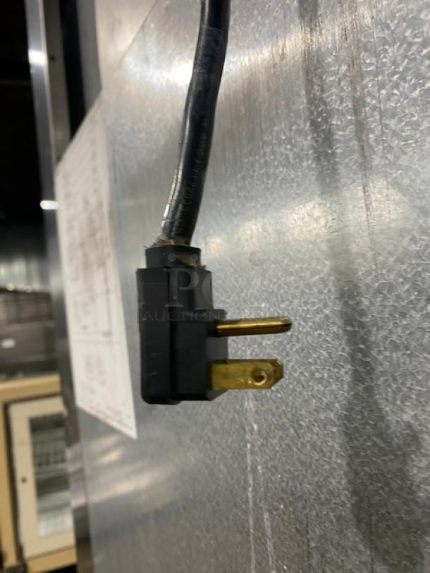 Traulsen commercial refrigerator plug, 115V, for Model ARI132LUTFHS, solid stainless steel, on casters, visible serial tag.