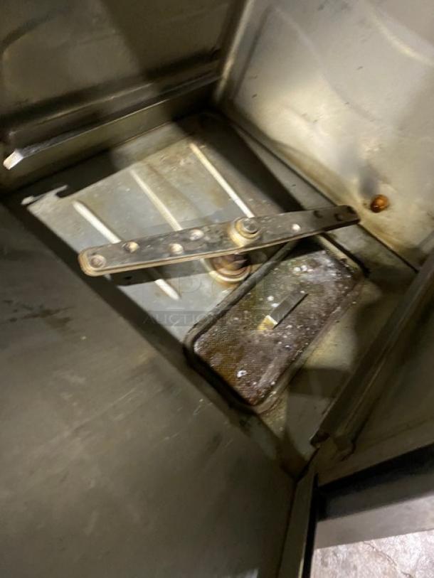 Champion UH130BM4 stainless steel undercounter dishwasher interior, high-temperature use, electric-powered, 120-208/230V.