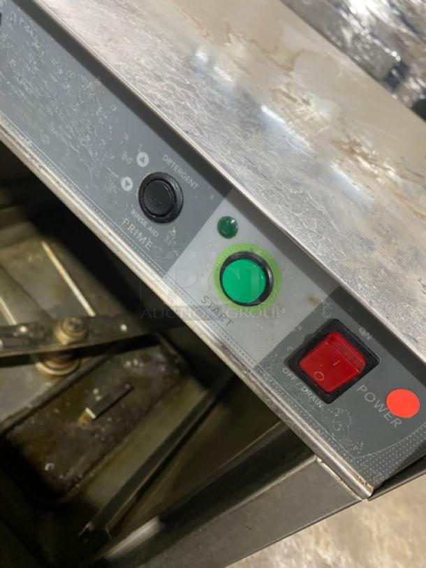 Champion UH130BM4 stainless steel undercounter dishwasher, electric powered, controls visible, lightly worn condition.