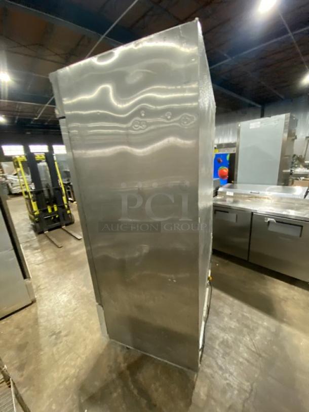 Avantco CFD-2RR commercial stainless steel 2-door refrigerator, poly-coated rack, 115V, 1 phase, on casters, side view.