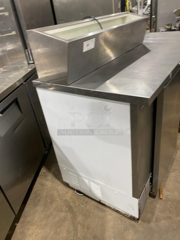 Beverage Air commercial stainless steel pizza prep table, extra-large workspace, two-door cold storage, poly-coated rack.