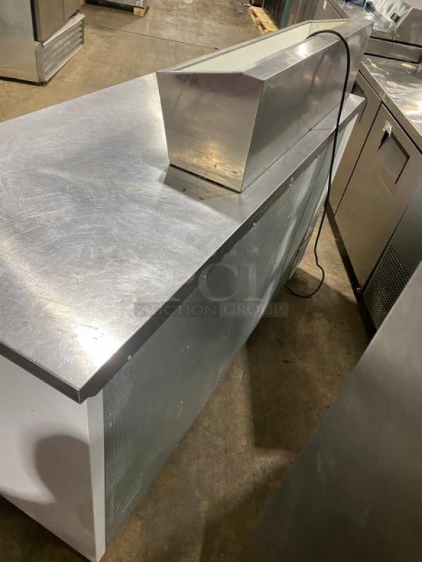 Beverage Air stainless steel refrigerated pizza prep table, extra-large workspace, two-door cold storage, poly-coated racks.