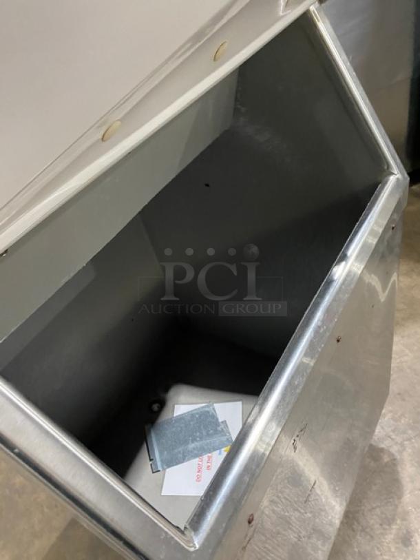 Manitowoc stainless steel ice machine bin, Model RNF0620W. Air-cooled, 115V, 1 phase, on legs, open bin view.