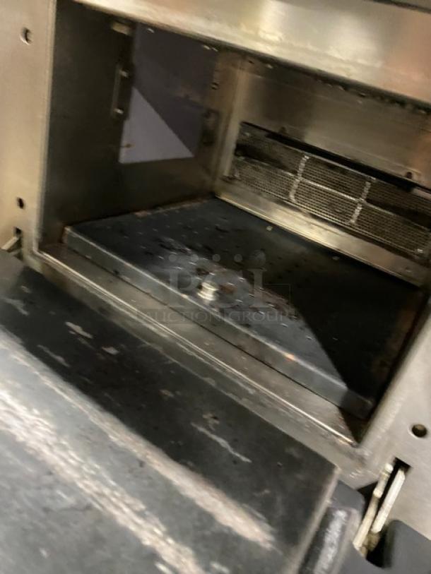 Late model MerryChef commercial stainless steel electric turbo oven with wired rack. Interior shows signs of wear.