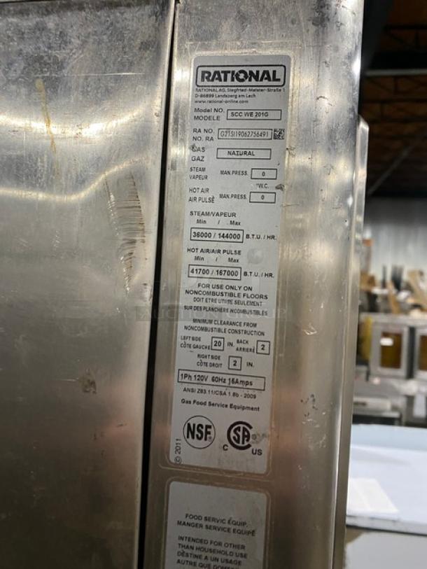 Rational SCCWE201G stainless steel combi oven, commercial-grade, electric-powered. Model and specs label visible, sturdy legs.