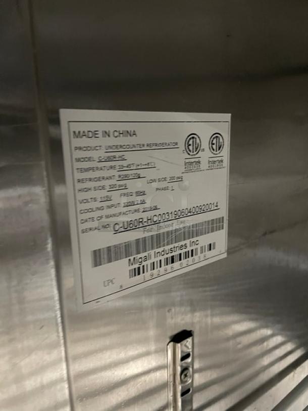 Migali C-U60R-HC stainless steel 2-door undercounter refrigerator. Features include poly coated rack, model details, and casters.