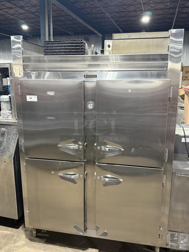 Traulsen 4 split door reach-in cooler with chrome rack shelving, 115V, 1 phase, on legs. Stainless steel, commercial-grade.