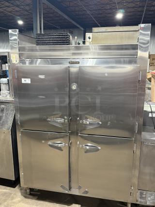 Traulsen 4 split door reach-in cooler with chrome rack shelving, 115V, 1 phase, on legs. Stainless steel, commercial-grade.