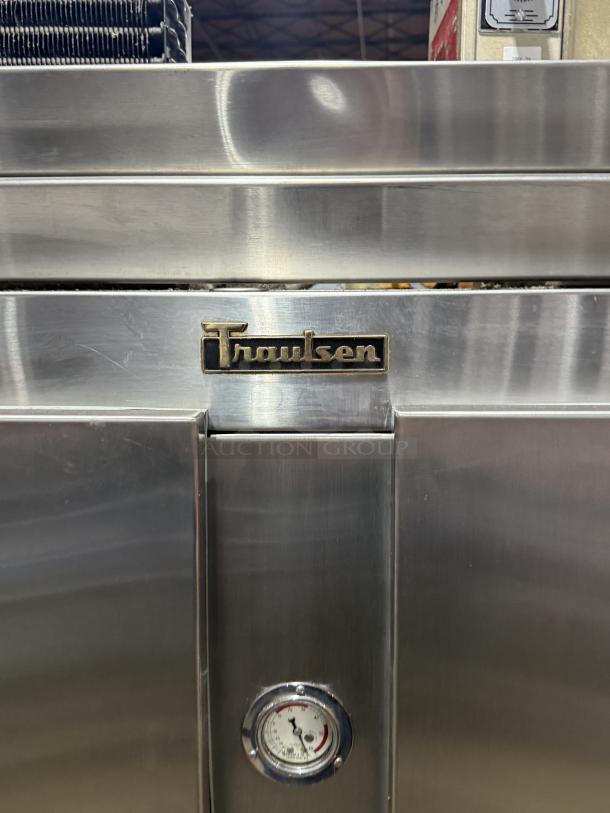 Traulsen 4 split door reach-in cooler with chrome rack shelving, stainless steel finish, 115V 1 phase, on legs.