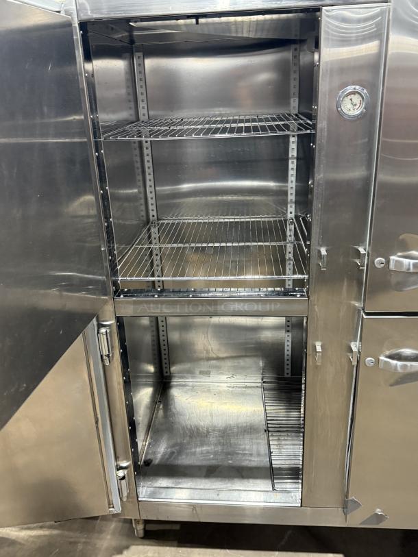 Traulsen 4 split door reach-in cooler with chrome rack shelving, 115V 1-phase, on legs. Visible inside compartments and thermometer.