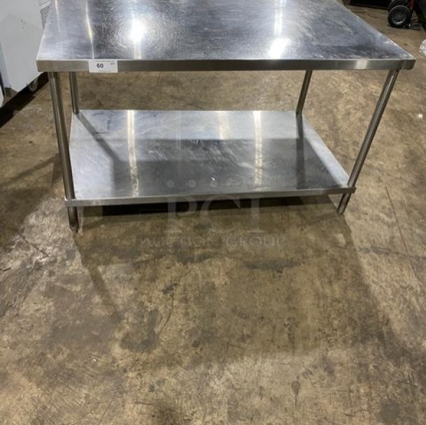 Commercial stainless steel equipment stand with single undershelf, sturdy legs, excellent condition, ideal for heavy use.