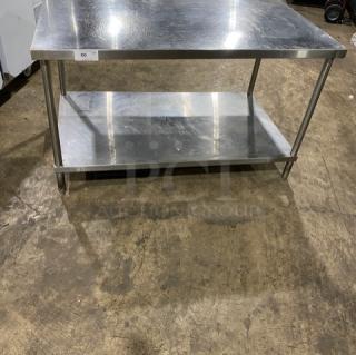 Commercial stainless steel equipment stand with single undershelf, sturdy legs, excellent condition, ideal for heavy use.