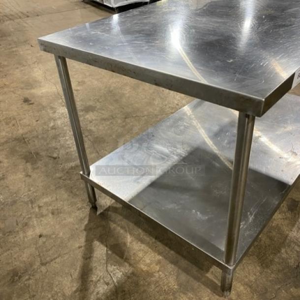 Commercial stainless steel equipment stand with single undershelf on sturdy legs, excellent condition, ideal for kitchens.